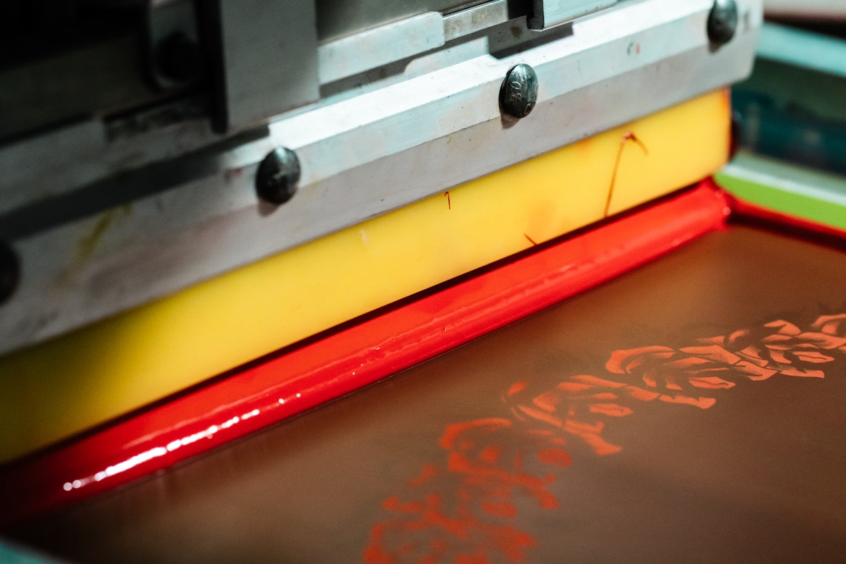 Close-up of screen printing with red ink.